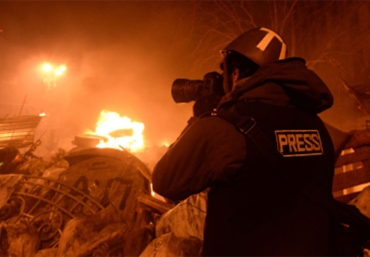 Journalist photographing scene of a fire