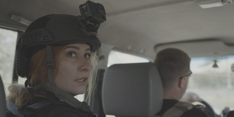 A photo of Valeriya Yegoshyna in a car. She's wearing a helmet with a go-pro attached.