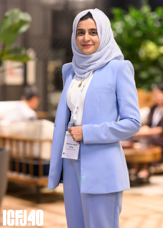 A photo of Hamna Iqbal Baig standing in a lobby.