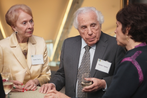 Seymour Topping and his wife, Audrey, speak with ICFJ President Joyce Barnathan at an ICFJ event.