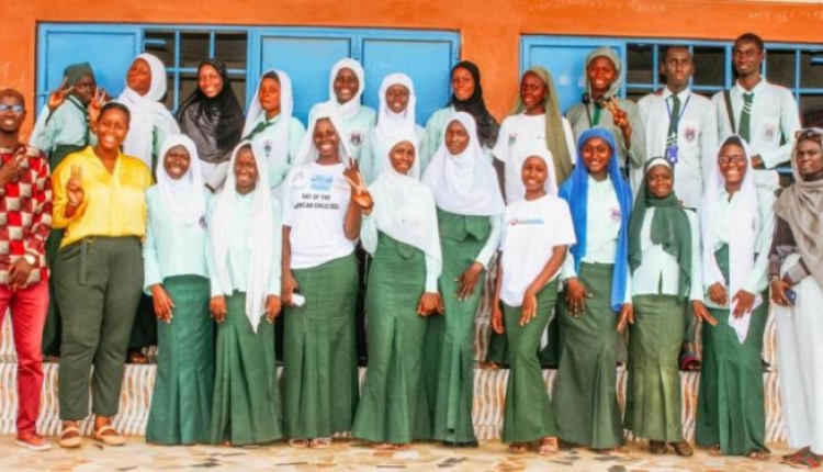 A photo of a group of students and instructors posing and smiling..