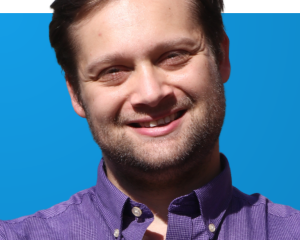 Portrait of Devin Windelspecht on blue background