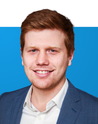 Headshot of Paul Rothman on blue background